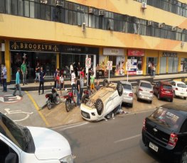 Colisão entre dois carros resulta em capotamento em frente a shopping